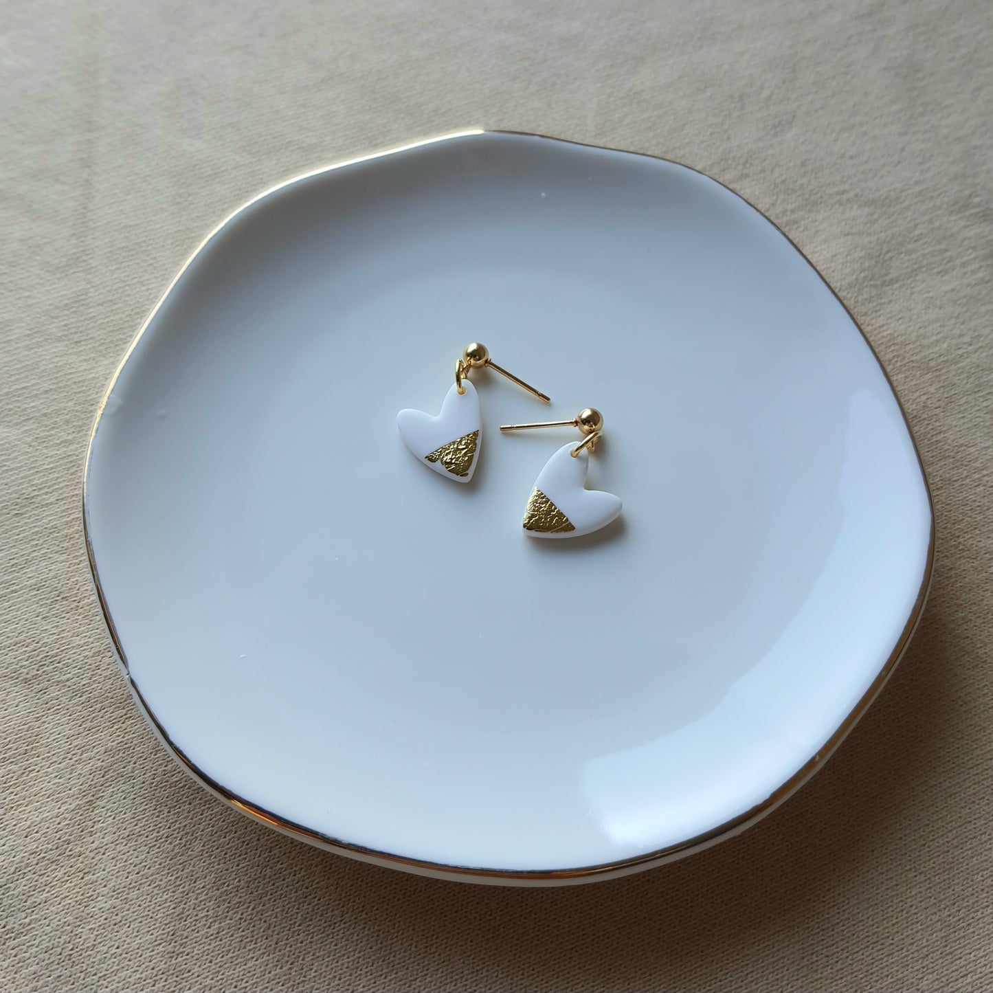 White hearts with golden flakes dangle earrings