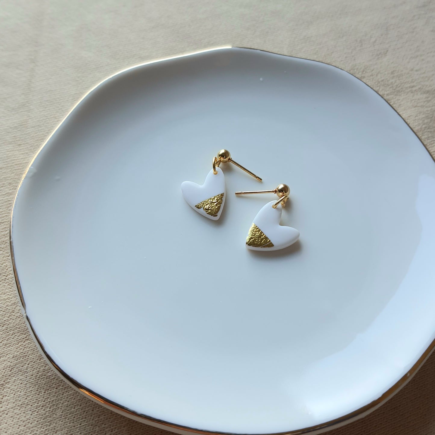 White hearts with golden flakes dangle earrings