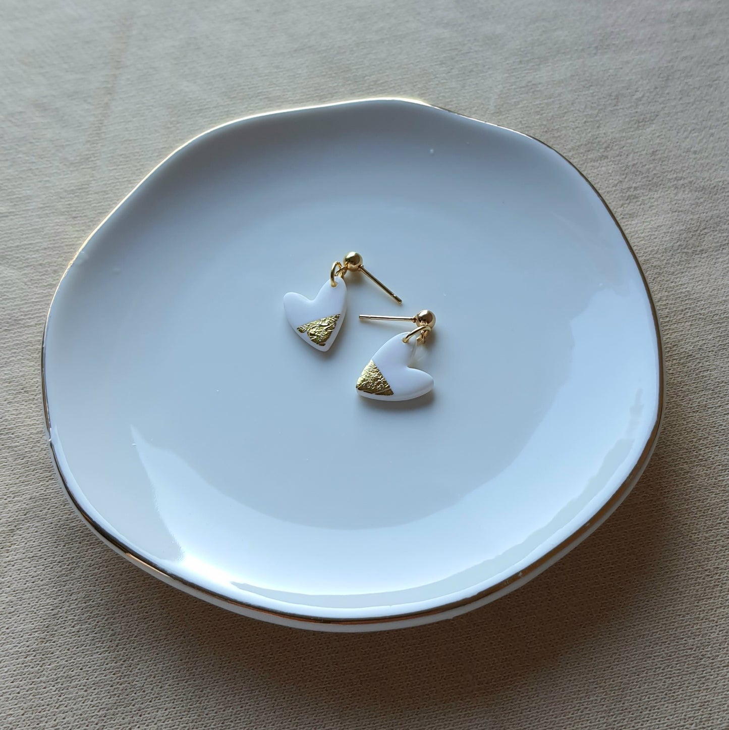 White hearts with golden flakes dangle earrings