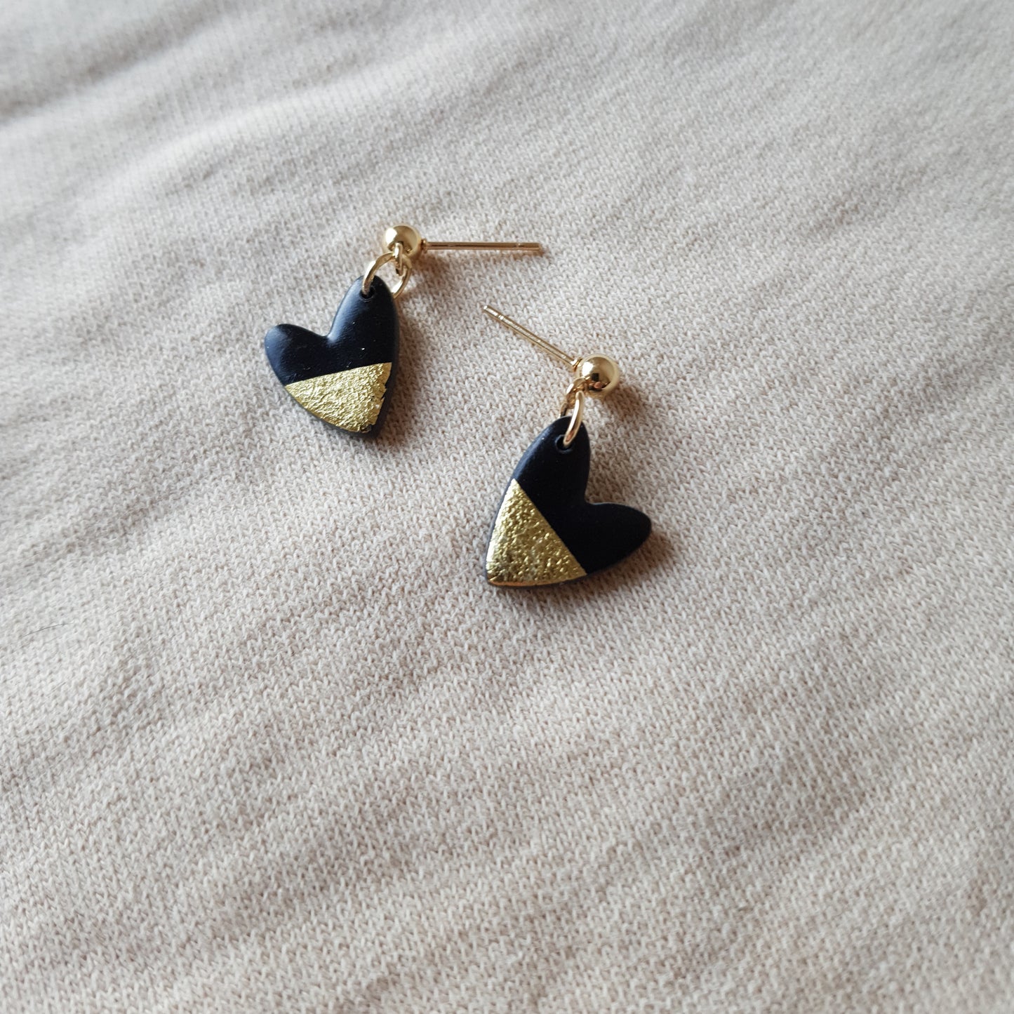 Black hearts with golden flakes dangle earrings