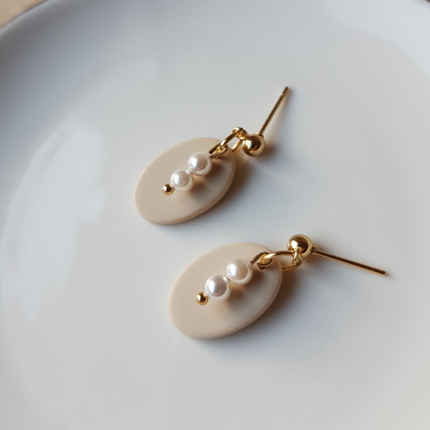 Neutral oval dangle earrings with glass beads