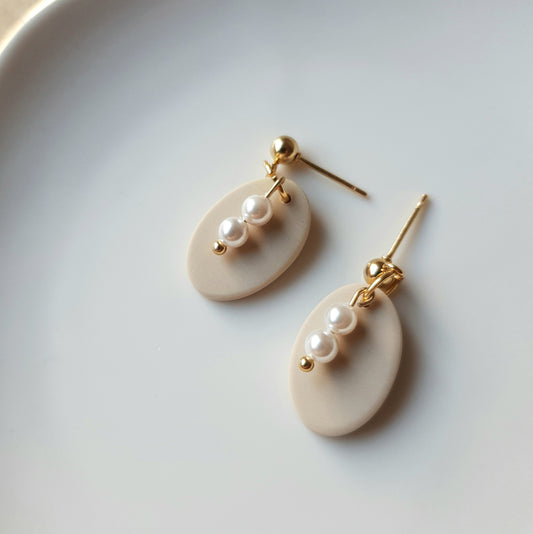 Neutral oval dangle earrings with glass beads