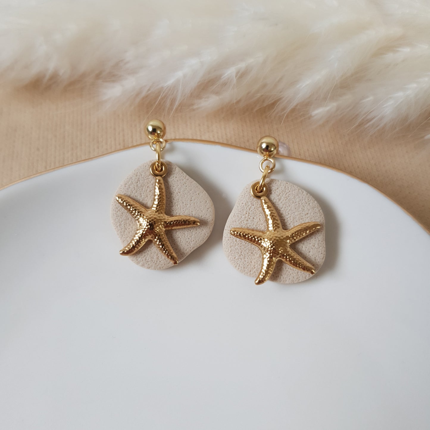 Gold stars on sand earrings