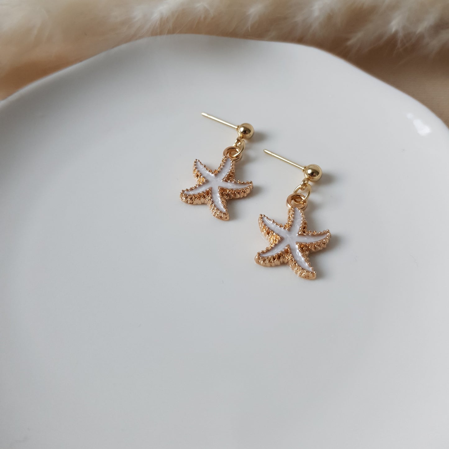 White sea star dangle earrings