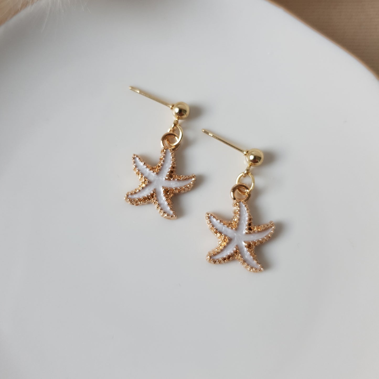 White sea star dangle earrings