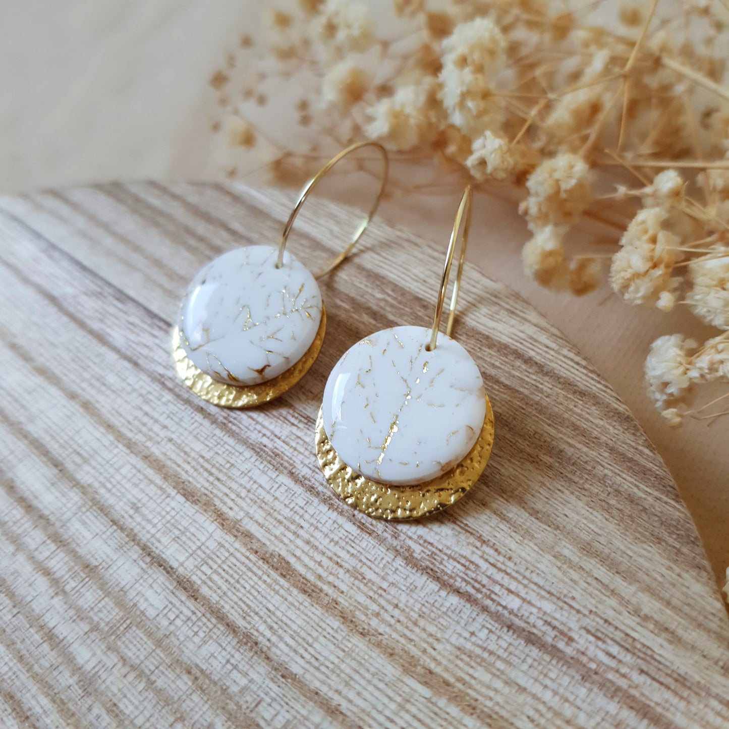White stone on gold hoop earrings
