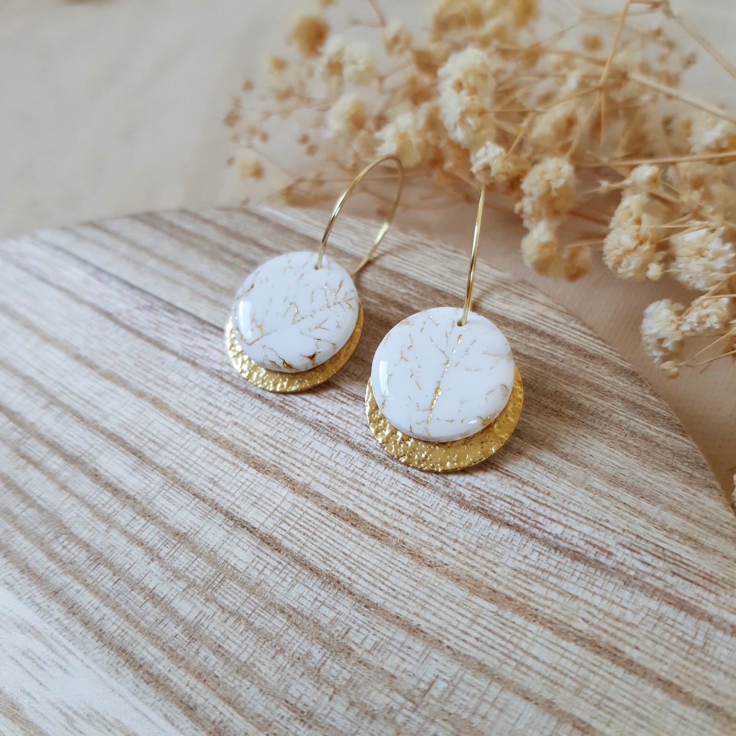 White stone on gold hoop earrings