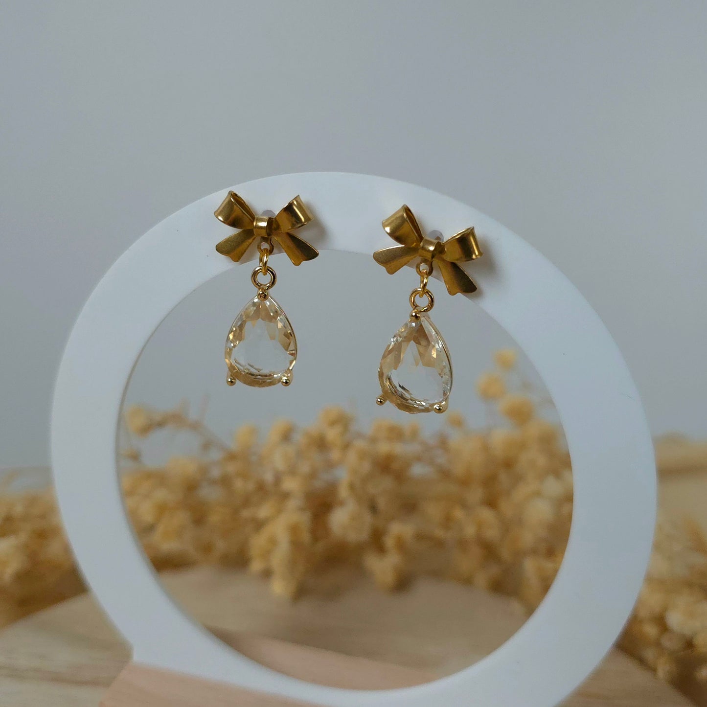 Golden bow and clear drop dangle earrings