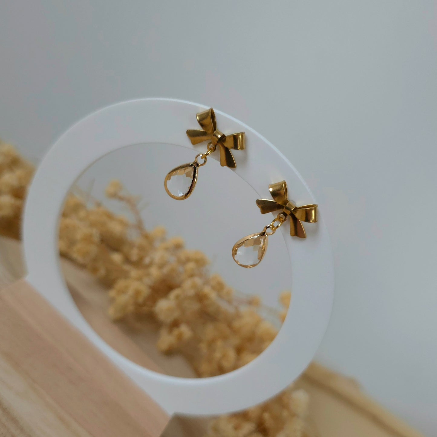 Golden bow and mini clear drop earrings