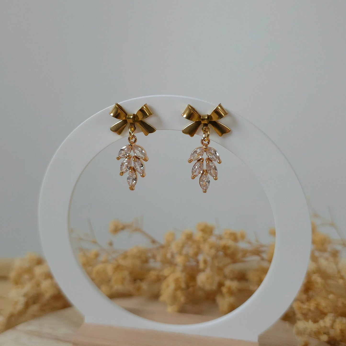 Golden bow and leaf earrings