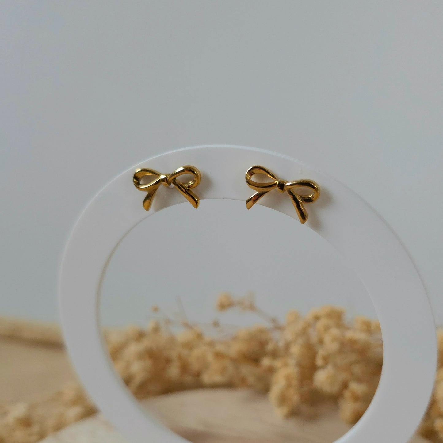 Golden bow stud earrings