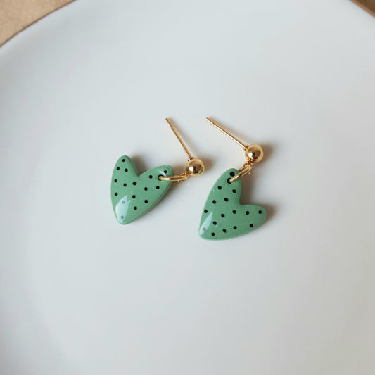 Green spotted dangly heart earrings