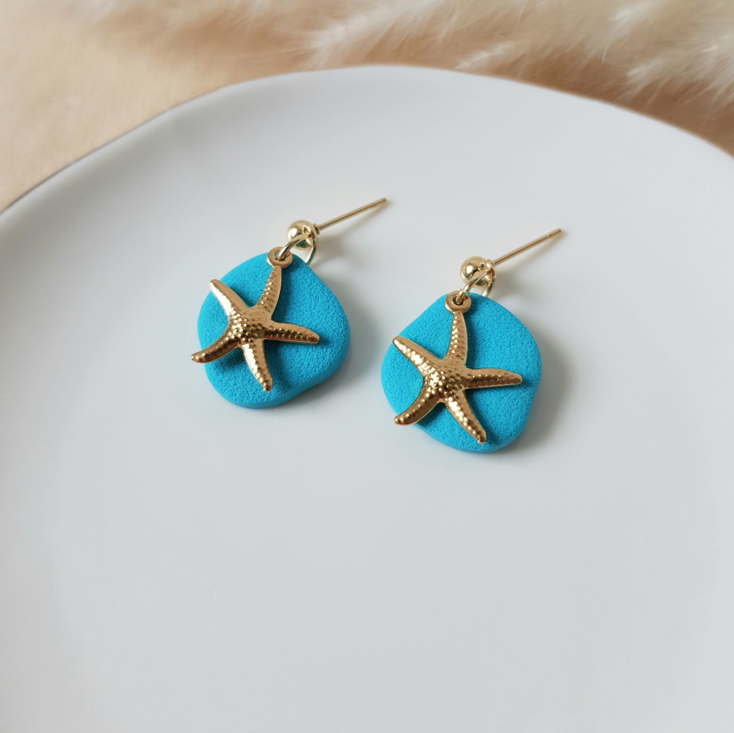 Turquoise earrings with gold sea star