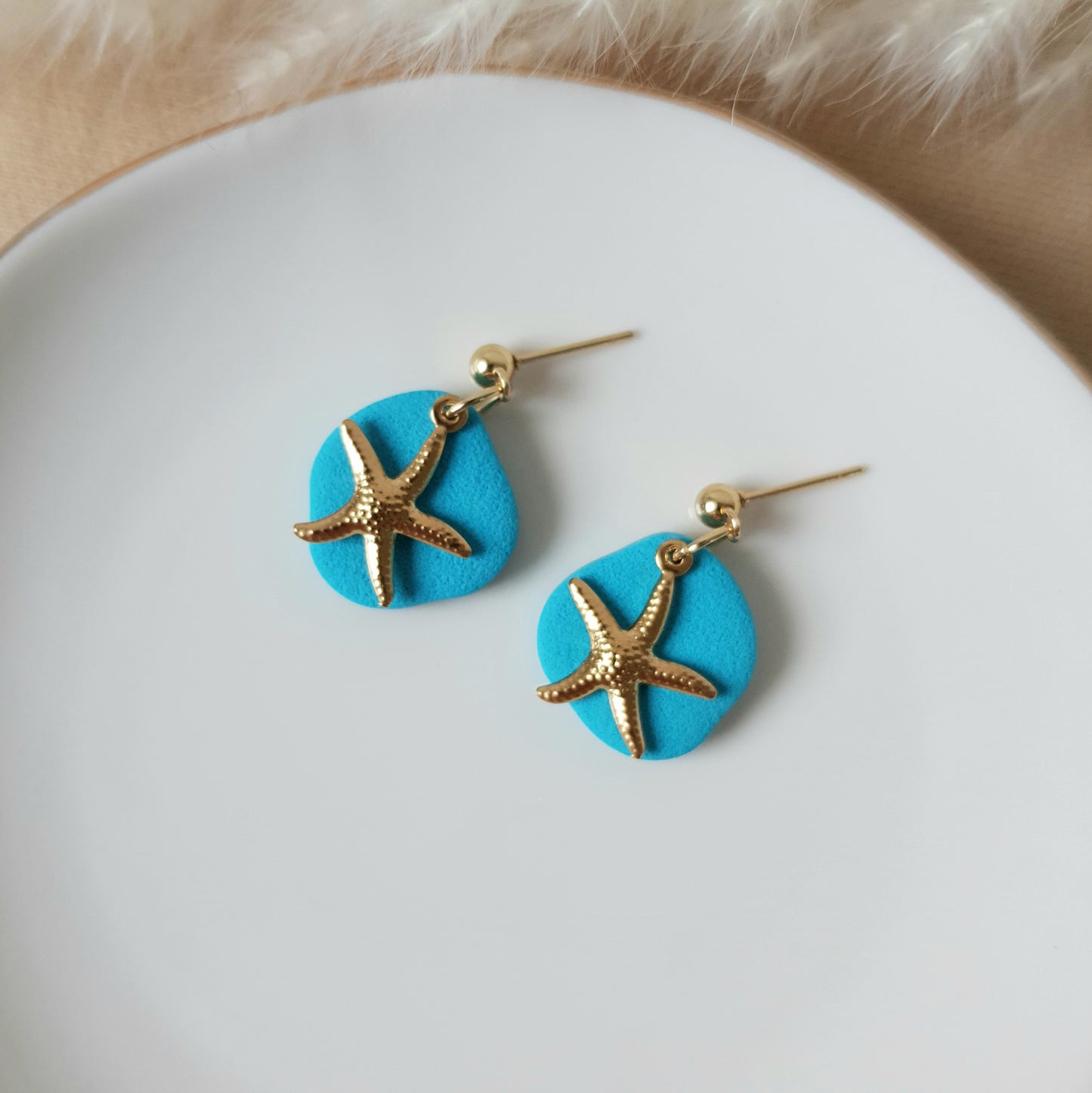 Turquoise earrings with gold sea star