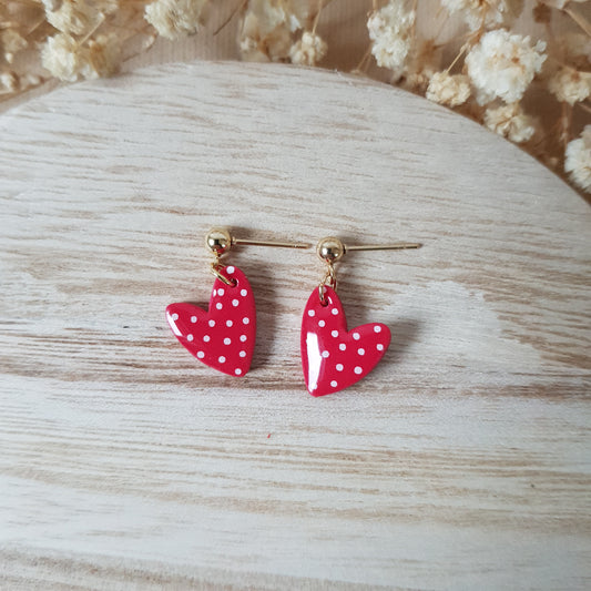 Asymmetric spotted red hearts