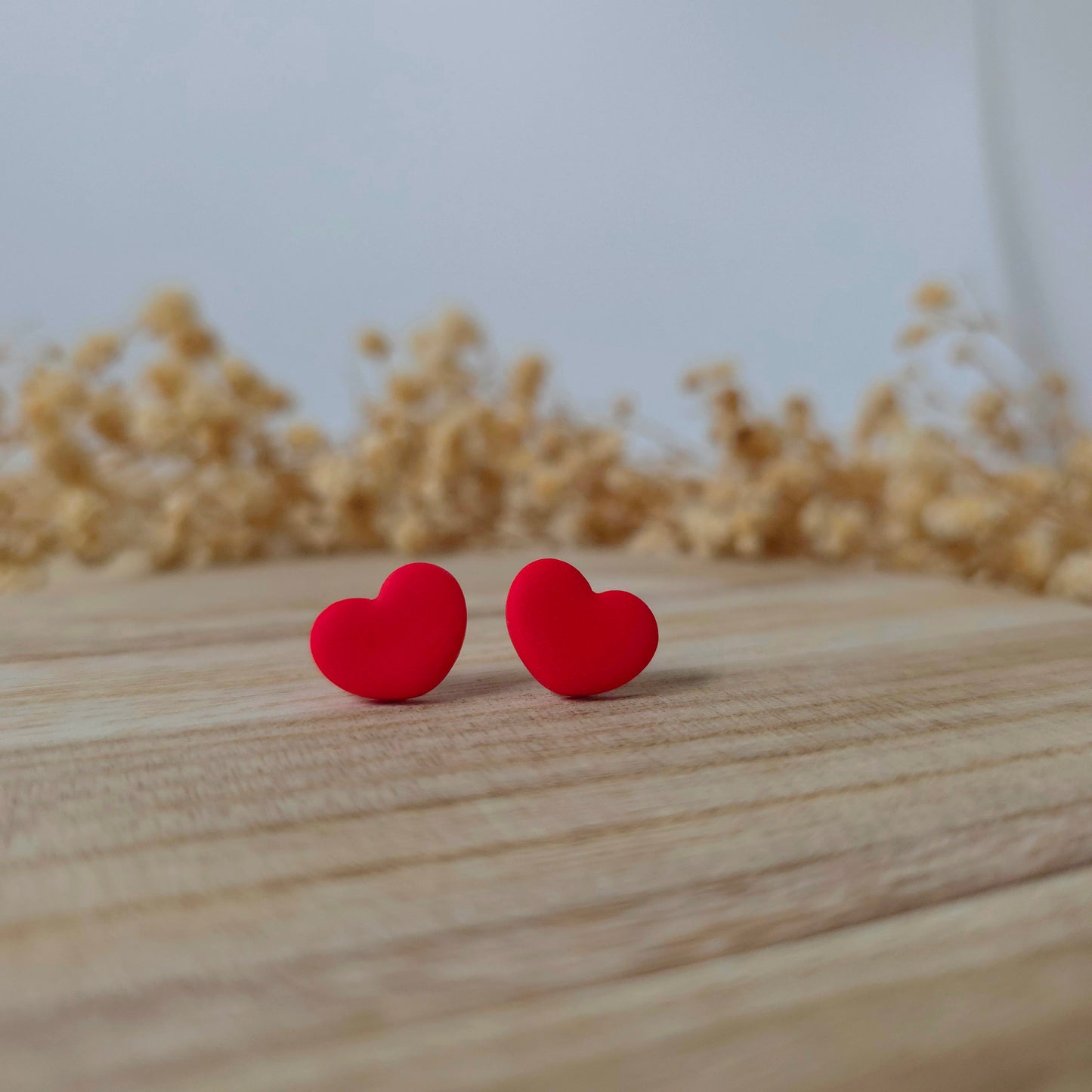Wide red heart stud earrings