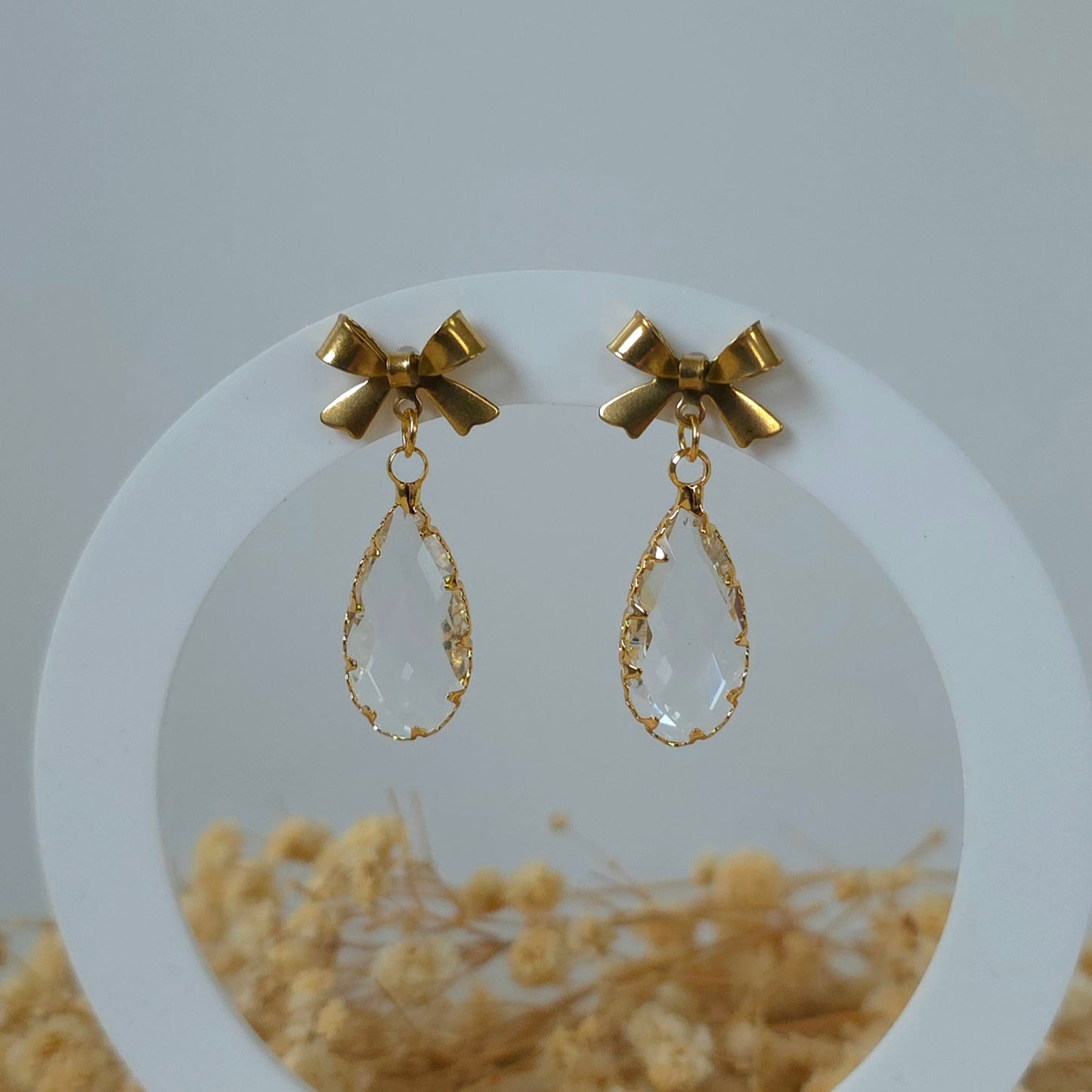 Gold and crystal bow dangle earrings