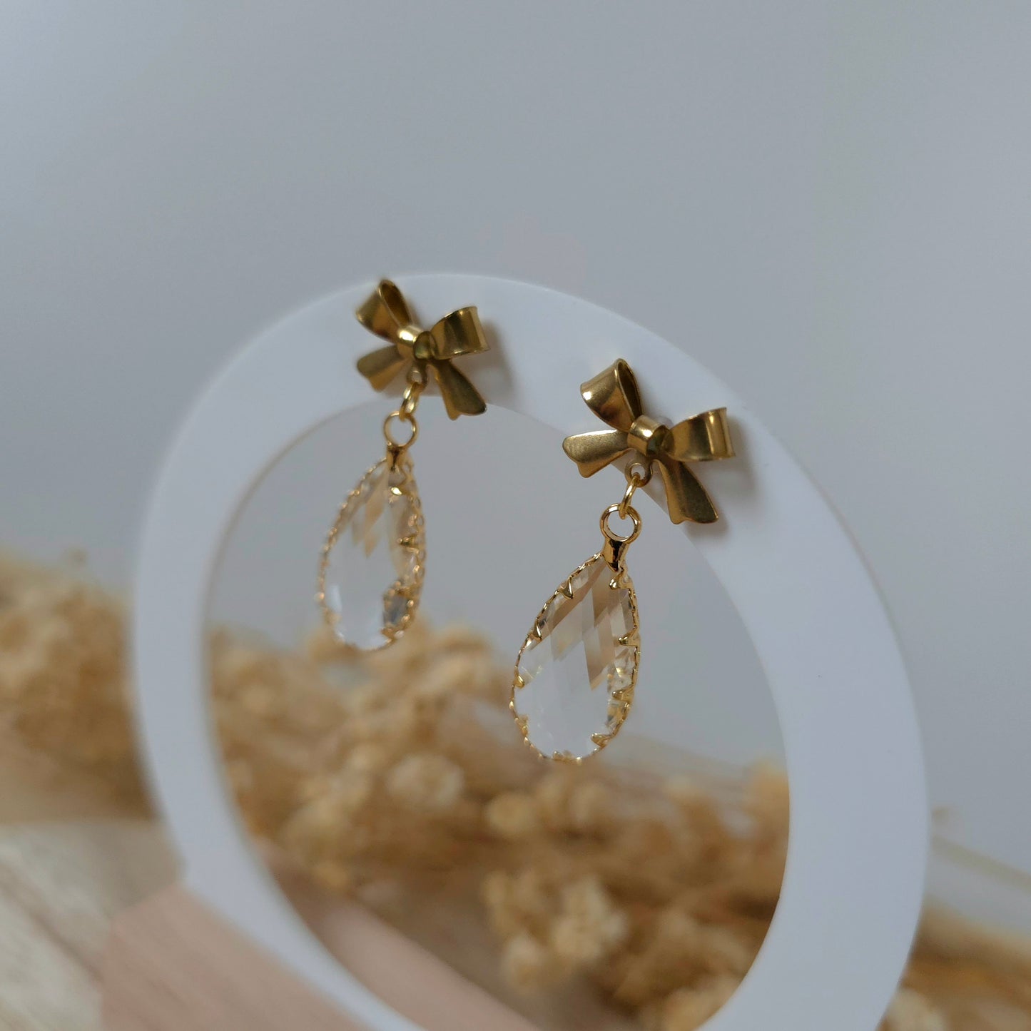 Gold and crystal bow dangle earrings