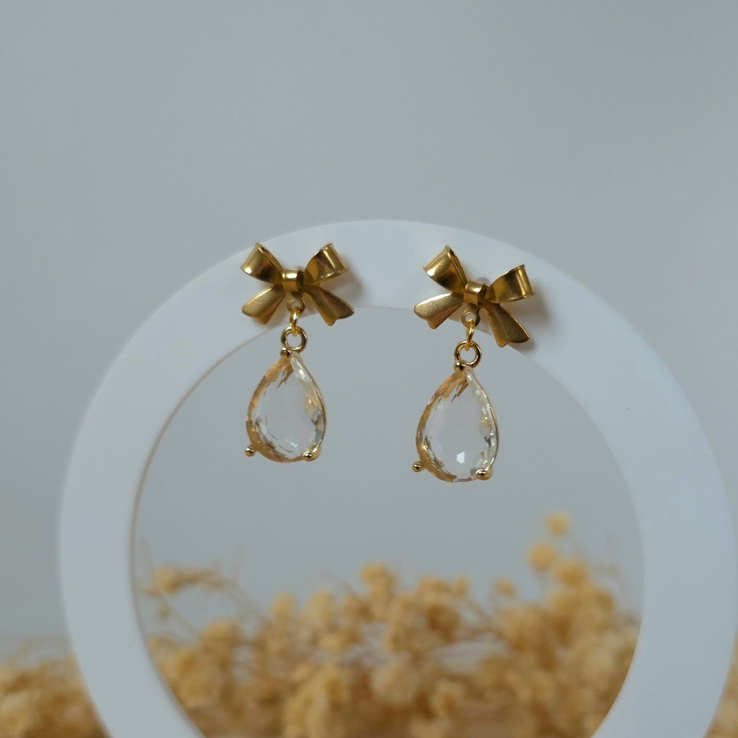 Golden bow and clear drop dangle earrings