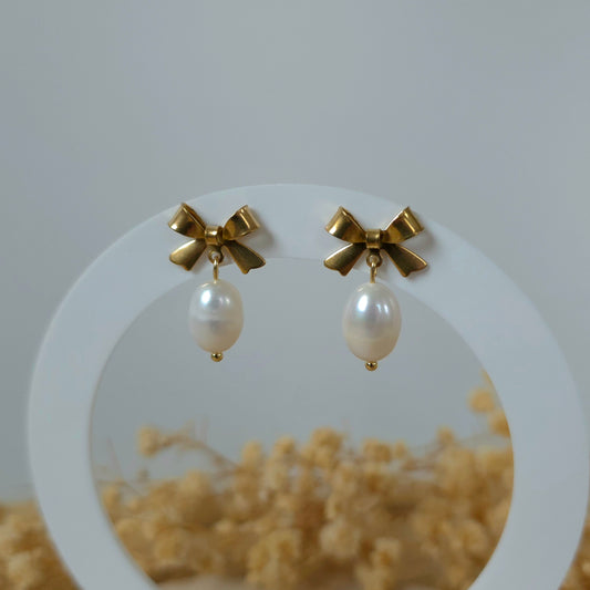 Golden bow and pearl earrings