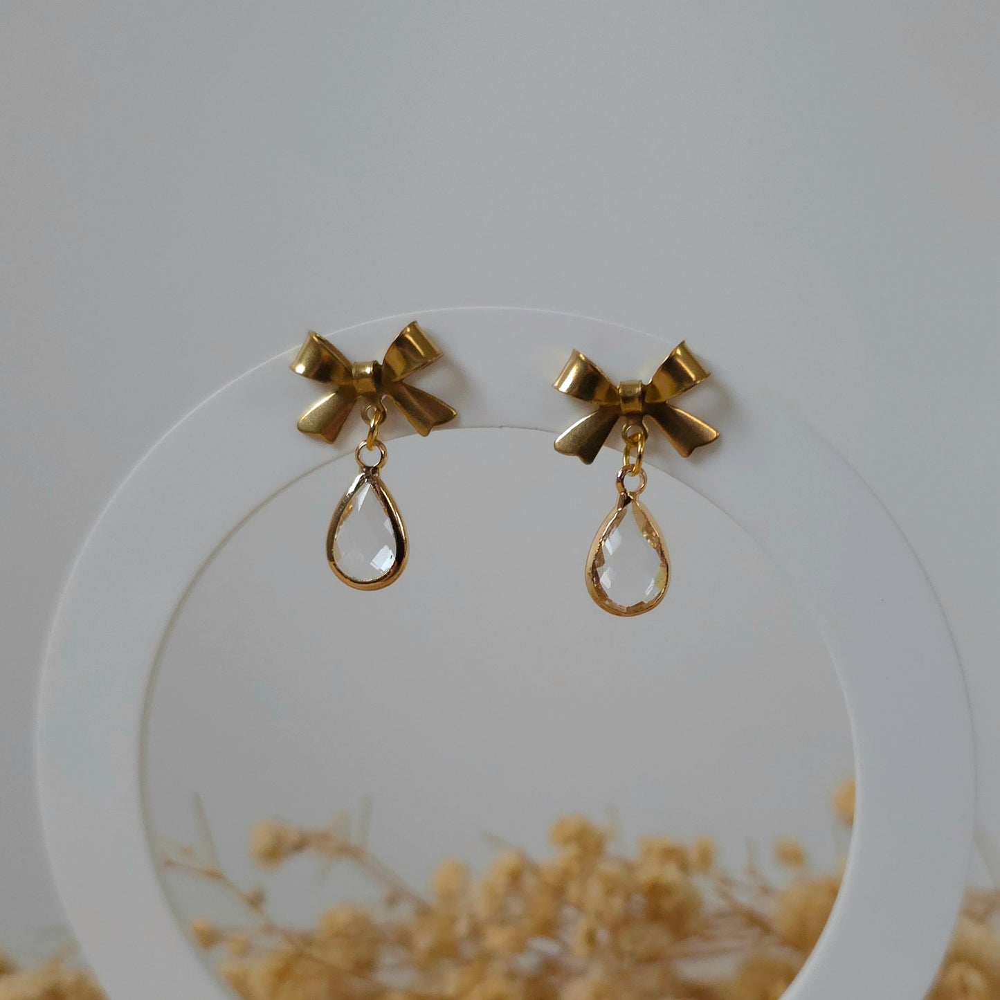 Golden bow and mini clear drop earrings