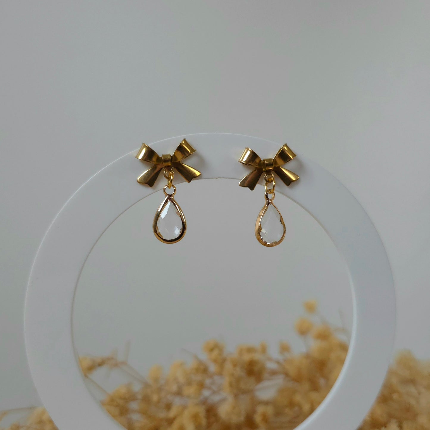Golden bow and mini clear drop earrings