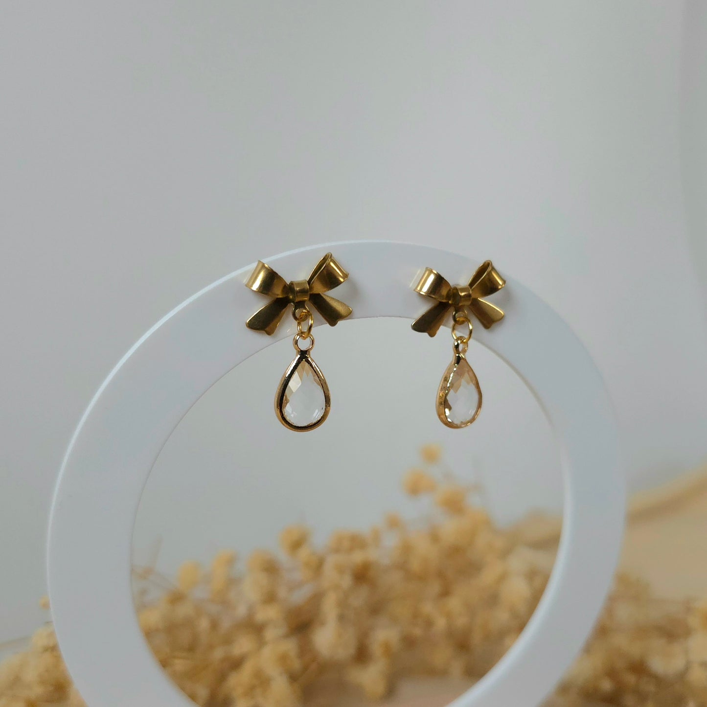 Golden bow and mini clear drop earrings