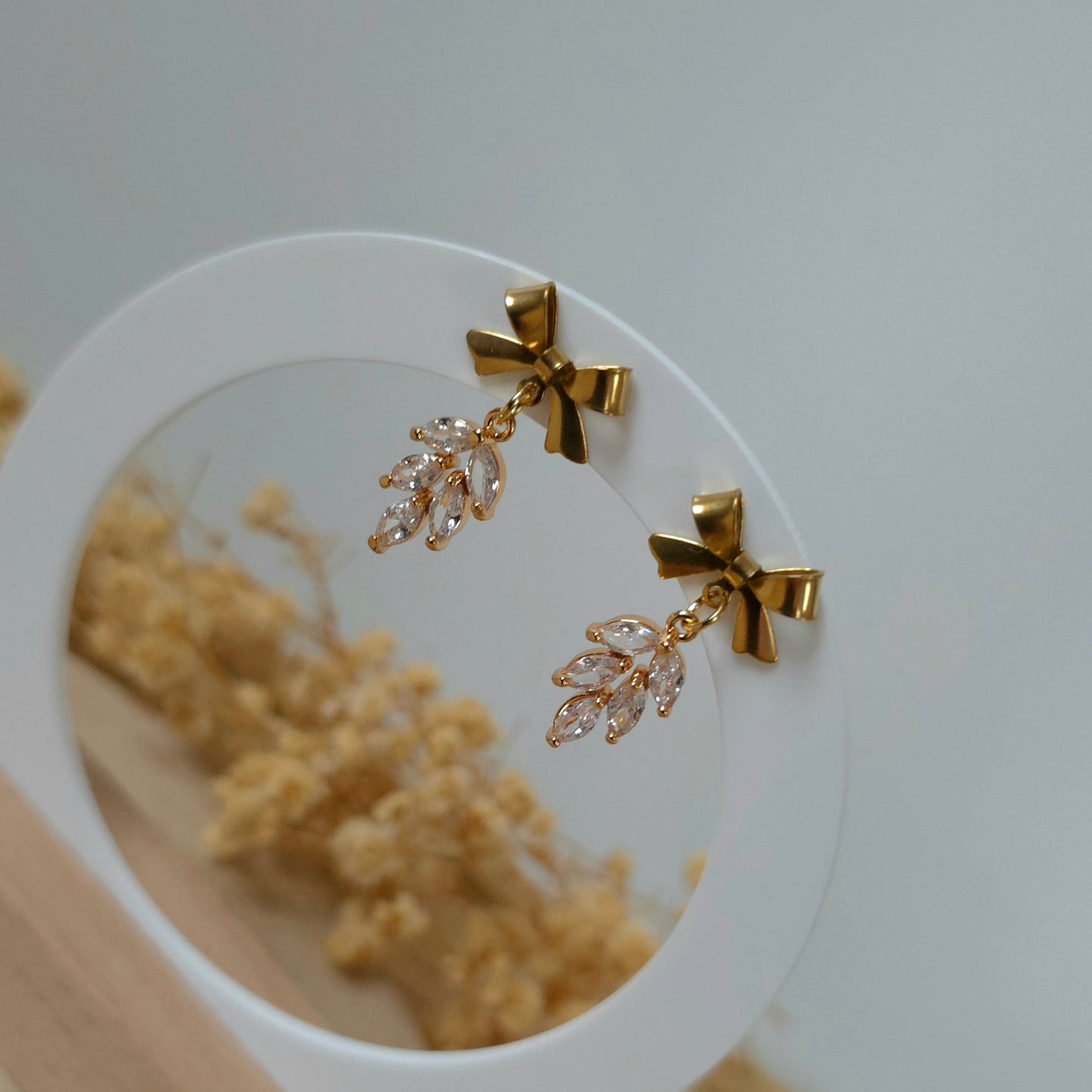 Golden bow and leaf earrings