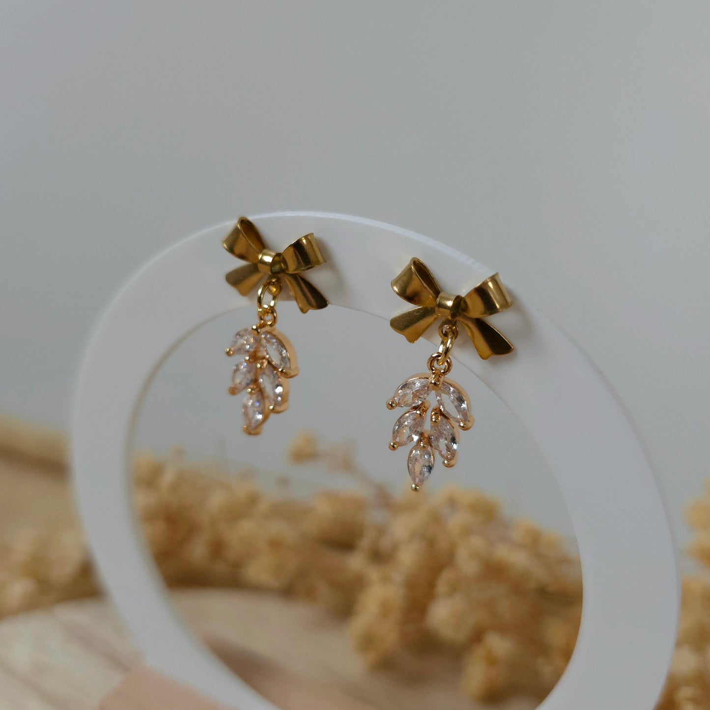 Golden bow and leaf earrings