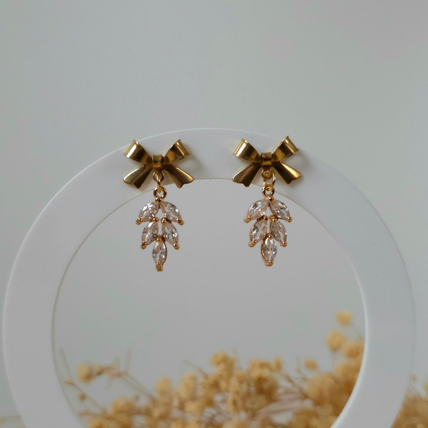 Golden bow and leaf earrings