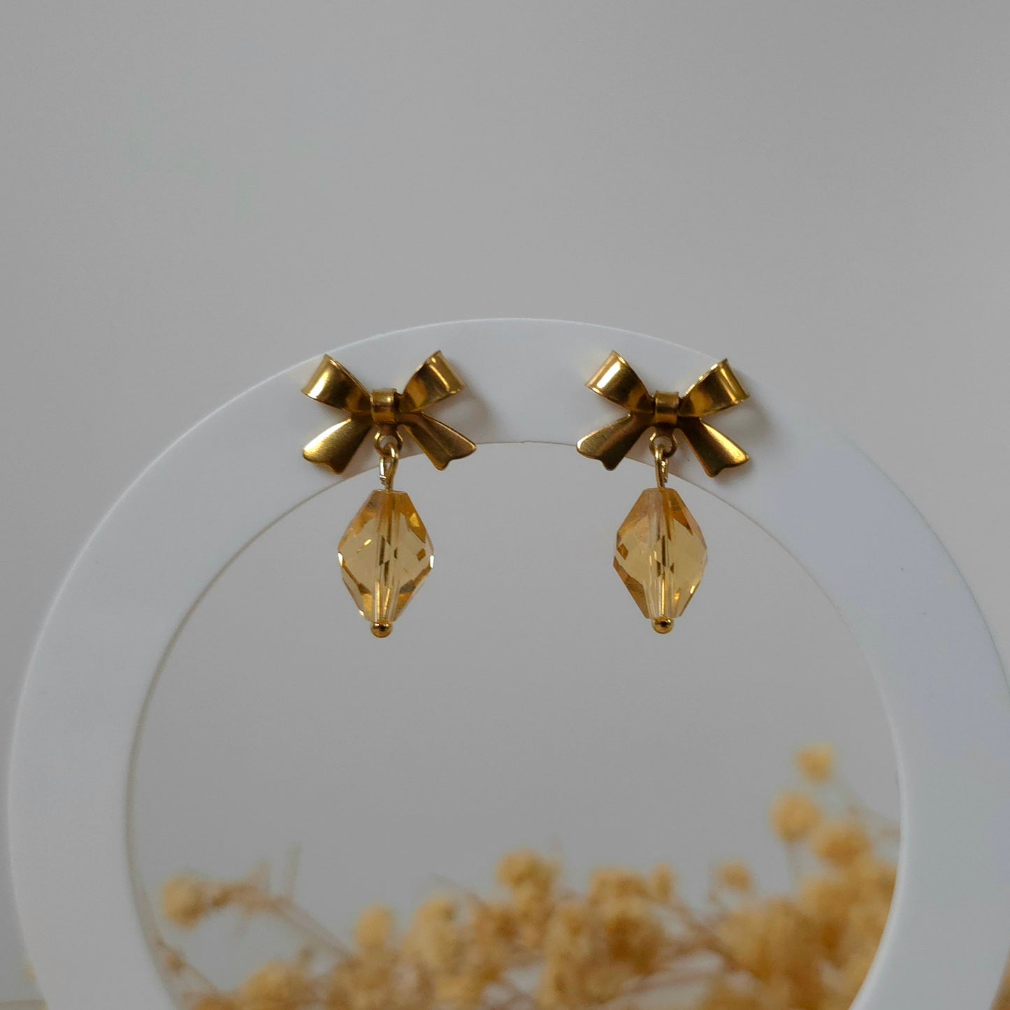 Golden bow dangle earrings
