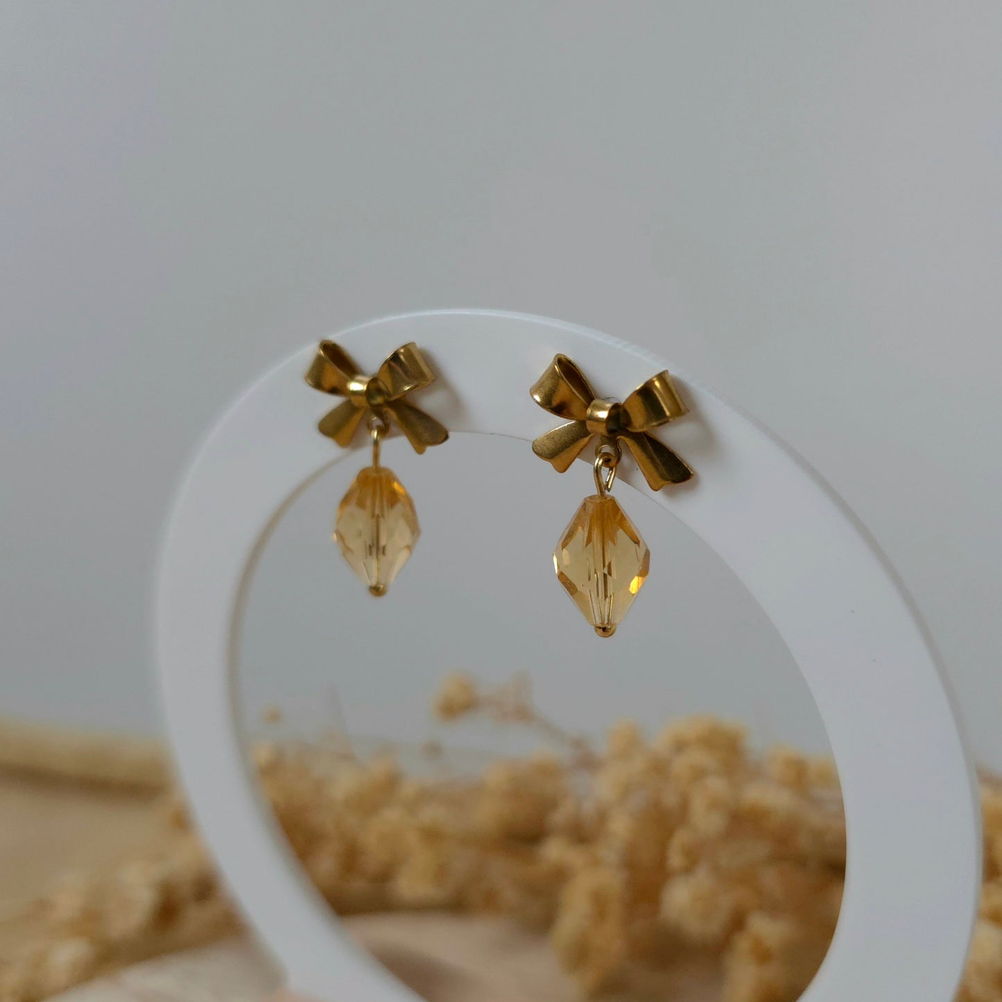 Golden bow dangle earrings