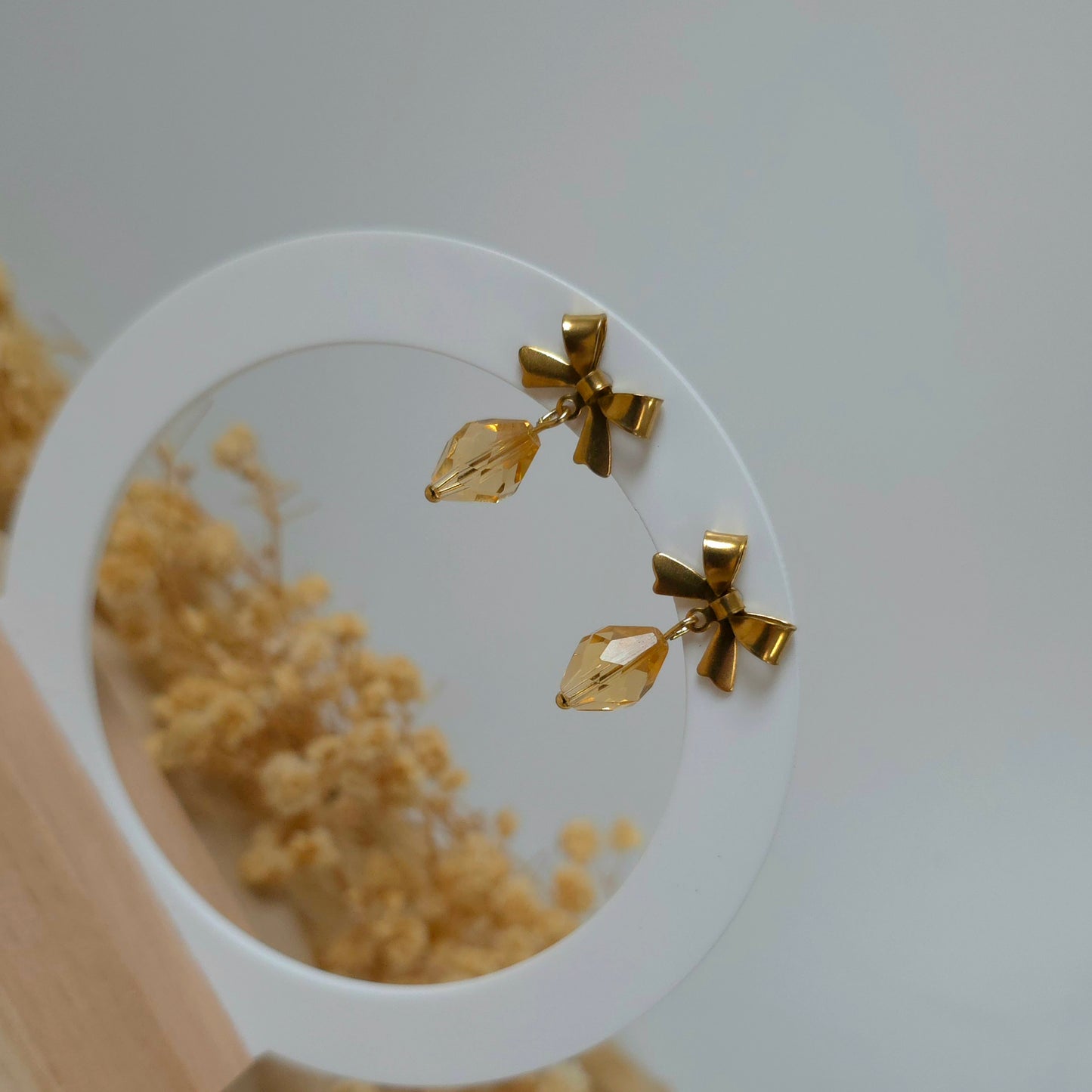 Golden bow dangle earrings