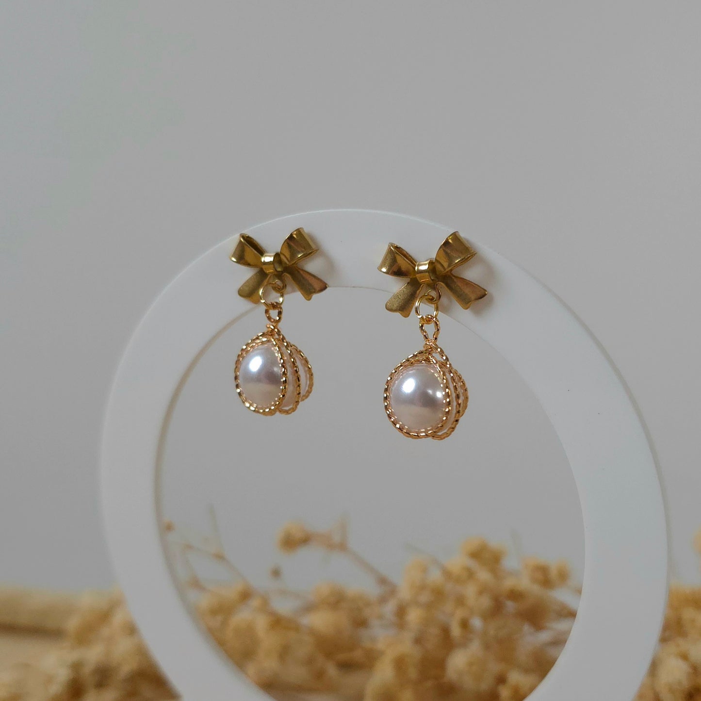 Golden bow and faux pearl earrings