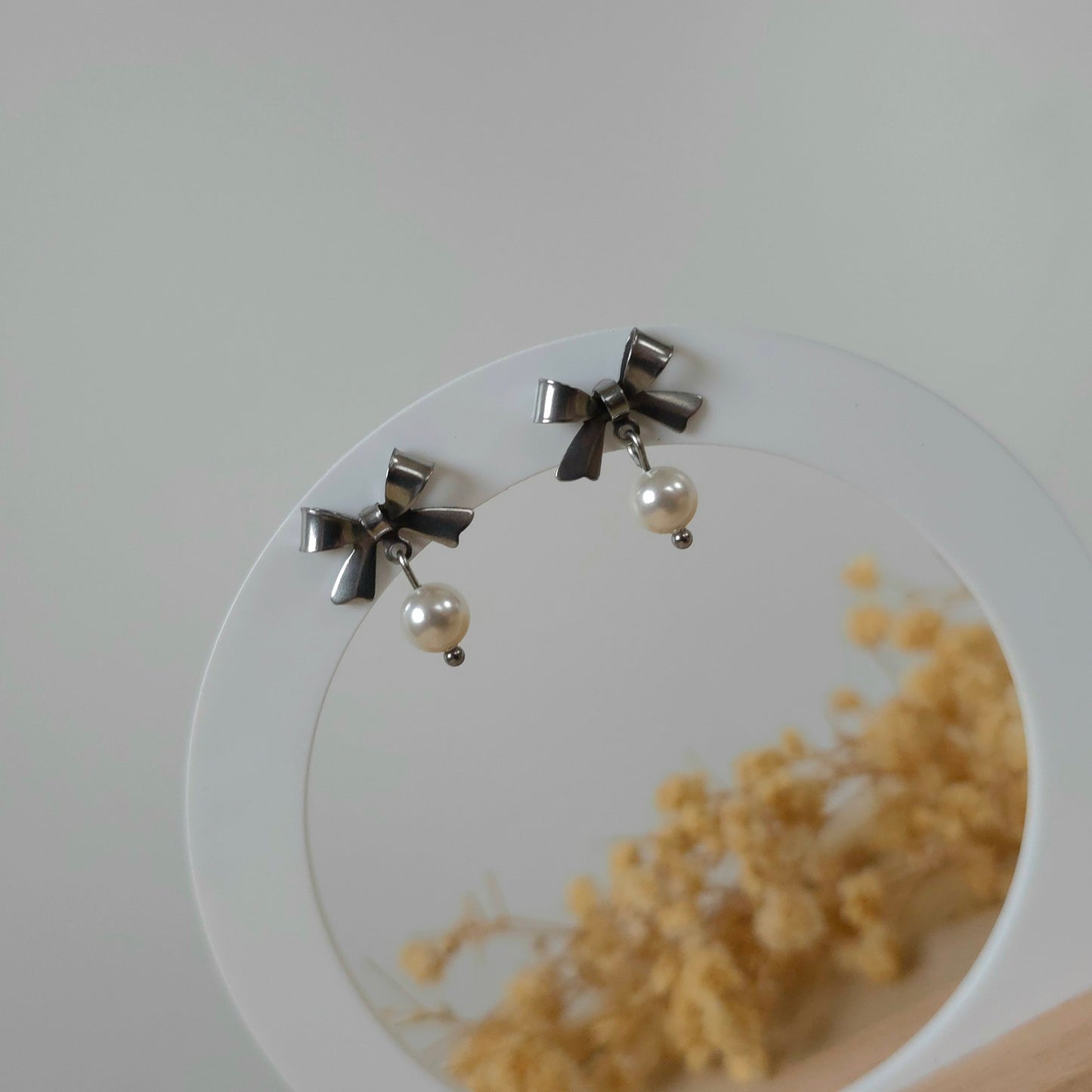 Silver bow and mini pearl earrings