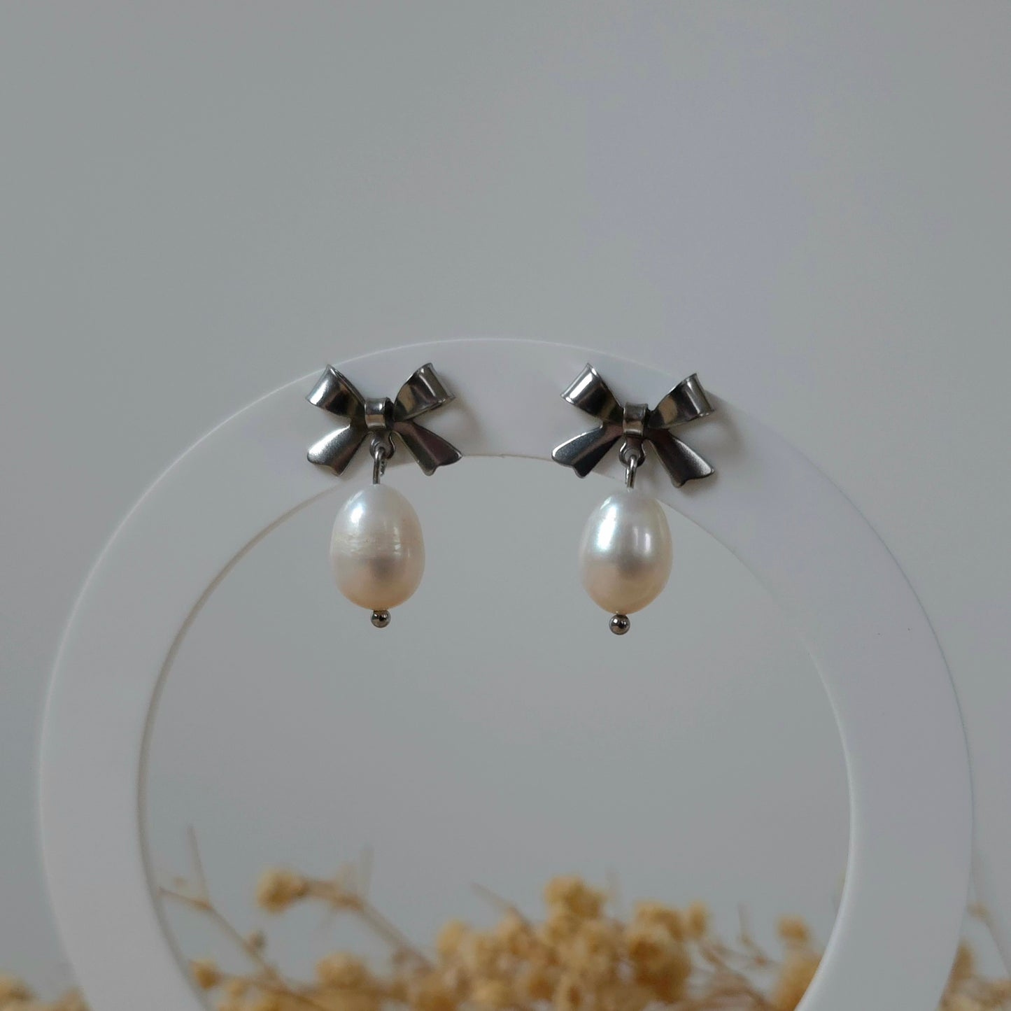 Silver bow and pearl earrings