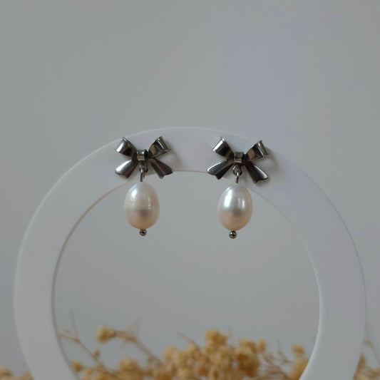 Silver bow and pearl earrings