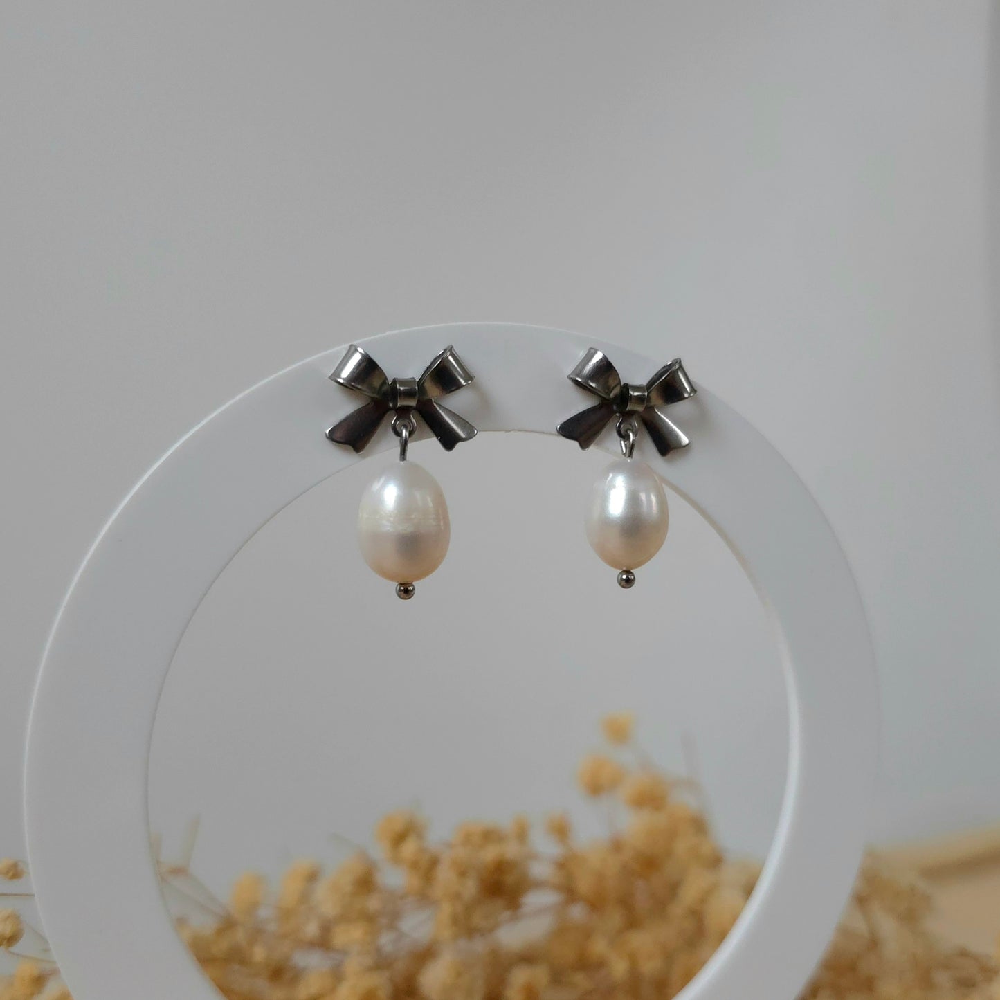 Silver bow and pearl earrings